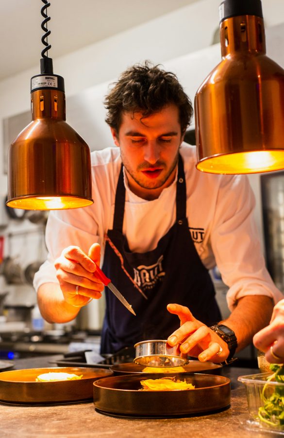 Chef carefully plating food in a premium kitchen